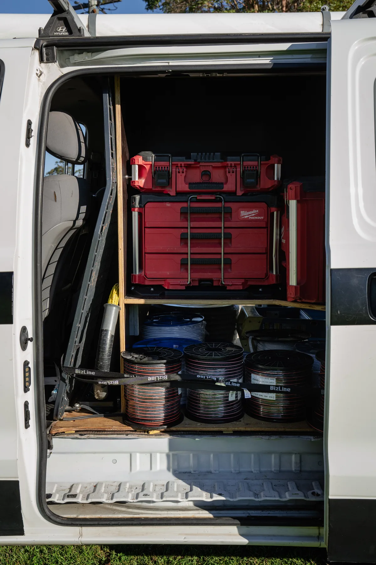 Side door of a van showing a completed plywood storage system