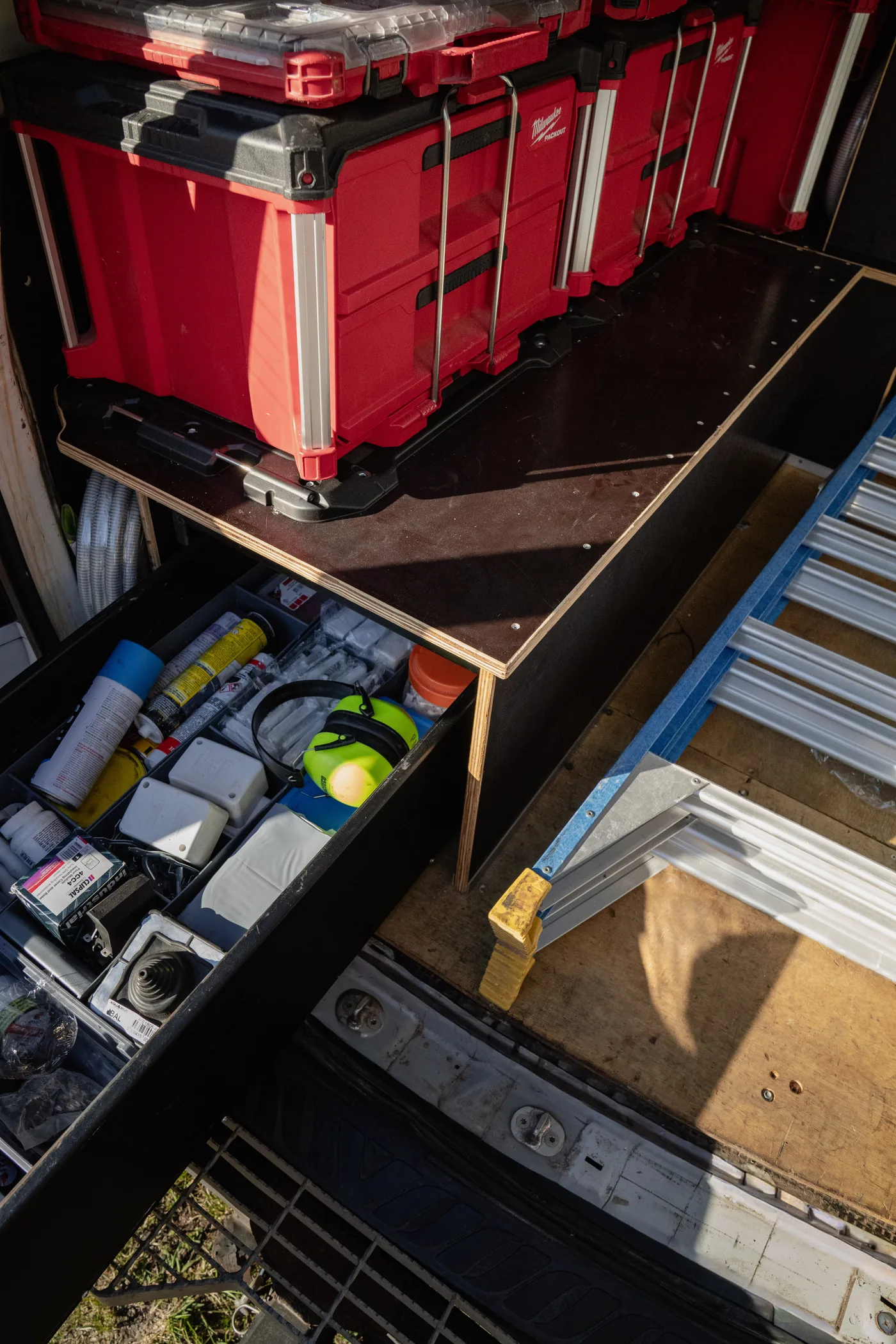 Slide-out drawer in a van fitout holding hand tools